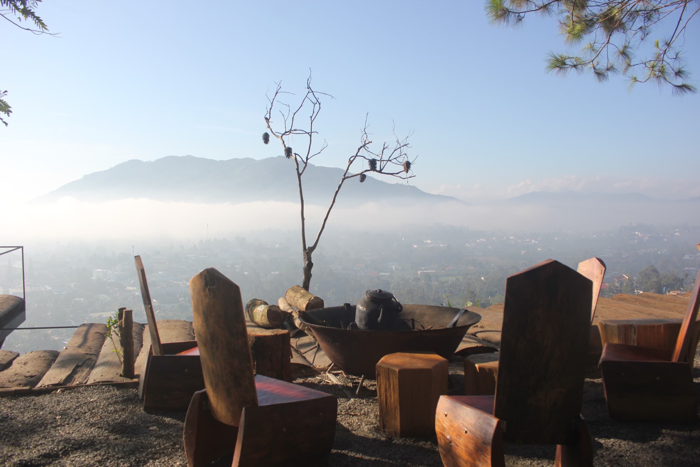 Misty mountain view from a hillside seating area