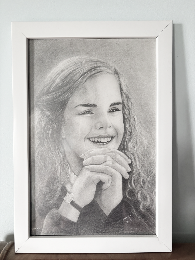 Pencil drawing portrait of a smiling young woman with curly hair